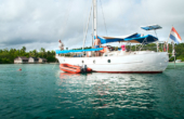 Sail Raja Ampat: A visiting boat moors for dinner at Ibu Maria's Homestay at Yenwaupnor village, Pulau Gam, Raja Ampat.