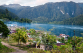 Evening at Warsambin on the channel to Teluk Mayalibit, Waigeo, Raja Ampat. Note the smoke from cooking fires blanketing the village